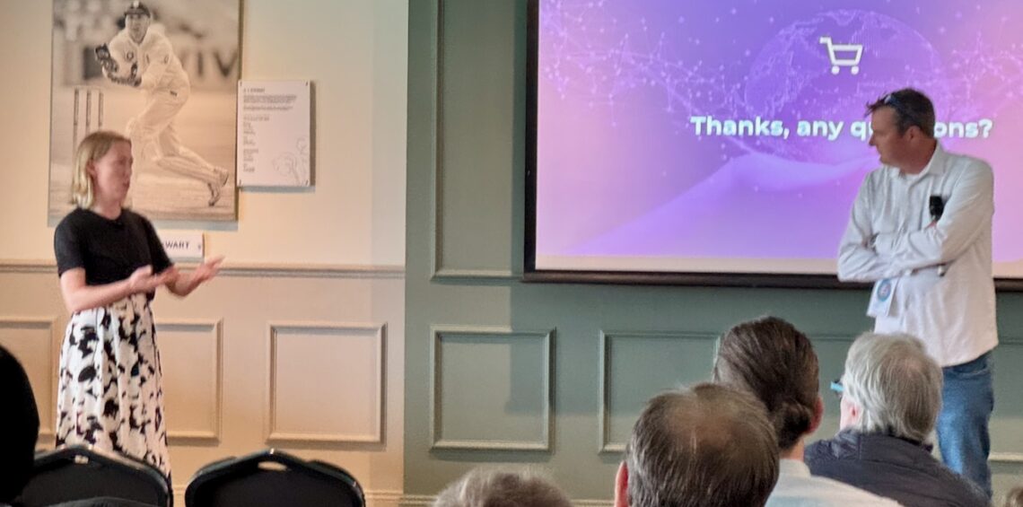 Presenter Charlotte Kiddle taking questions with conference chair AJ Johnson in front of an audience of people.